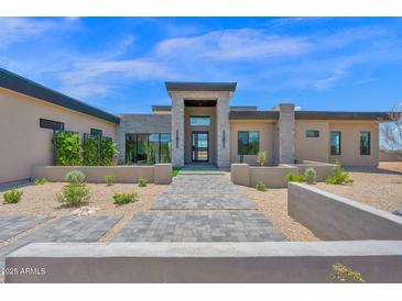 Stunning modern home featuring a meticulously landscaped yard and stylish stone accents at 7261 E Via Dona Rd, Scottsdale, AZ 85266