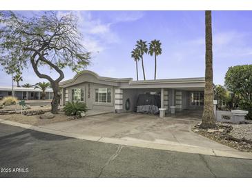Charming single-story home featuring a covered parking area and desert landscaping in a quiet neighborhood at 8240 E Pueblo Ave, Mesa, AZ 85208