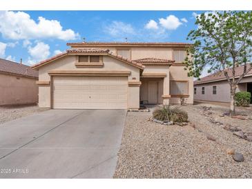 Two-story home with a two car garage, rock landscaping, and tile roof under a partly cloudy blue sky at 1978 E Connemara Dr, San Tan Valley, AZ 85140