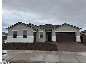 Charming single-story home featuring a two-car garage and neutral stucco exterior at 24098 N 172Nd Ave, Surprise, AZ 85387