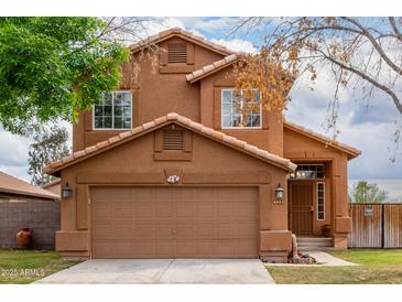 Charming two-story home with a well-maintained front yard and a two-car garage at 4053 W Quail Ave, Glendale, AZ 85308