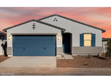 Charming single-story home showcasing a well-manicured front yard and a two-car garage at 41740 W Sonoran Trl, Maricopa, AZ 85138