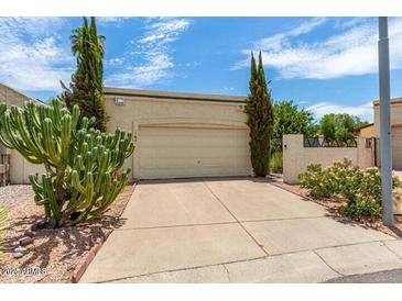 Single story home featuring a large cactus in the front yard and a two car garage at 630 E Jensen St # 162, Mesa, AZ 85203