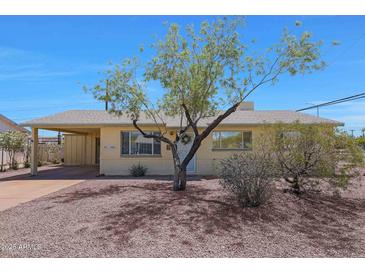 Charming single-story home with covered parking and desert landscaping at 1763 W Pepper Pl, Mesa, AZ 85201