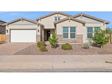 Charming home with manicured front yard and stone accents offers curb appeal at 18324 W Highland Ave, Goodyear, AZ 85395