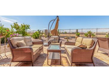 Inviting patio featuring cushioned seating and outdoor accents perfect for relaxation at 19932 N Ibis Way, Maricopa, AZ 85138