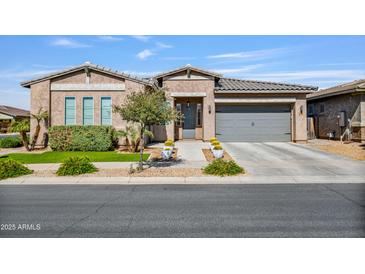 Charming single-story home with a well-manicured front yard and a neutral color palette, showcasing its curb appeal at 22744 E Stonecrest Dr, Queen Creek, AZ 85142
