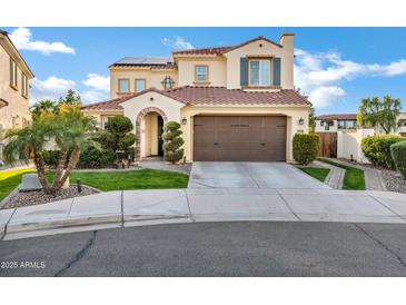Charming two-story home with a beautiful tile roof, green lawn, and a two car garage at 2395 W Riverside St, Chandler, AZ 85248
