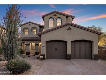 Stunning two-story home with a three car garage, well manicured desert landscaping, and stone accents at 3737 E Donald Dr, Phoenix, AZ 85050