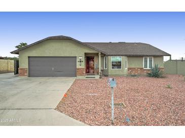 Charming single-story home featuring a two-car garage and low maintenance desert landscaping at 6461 E Jensen St, Mesa, AZ 85205