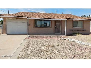 Charming single-story home featuring a gravel yard, and an attached garage with an exterior window at 11410 N 105Th Ave, Sun City, AZ 85351