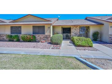 Charming single-story home featuring a well-maintained front yard with mature landscaping at 13423 W Countryside Dr, Sun City West, AZ 85375