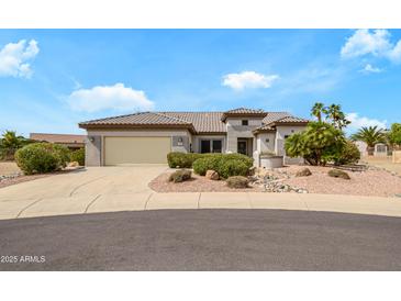 Inviting single-story home featuring desert landscaping and a two-car garage, perfect for low-maintenance living at 15750 W Linksview Dr, Surprise, AZ 85374