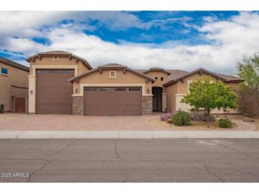 Charming single-story home with a three-car garage and brick driveway, professionally landscaped at 3209 W Spur Dr, Phoenix, AZ 85083