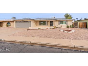 Charming single-story home with a xeriscaped front yard and a neutral-toned facade at 4126 E Carmel Ave, Mesa, AZ 85206