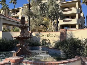 Condominium exterior view featuring a decorative fountain and the 'Marquessa' sign at 4200 N Miller Rd # 321, Scottsdale, AZ 85251