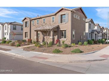 Charming two-story home featuring stone accents and desert landscaping at 5811 W Encinas Ln, Phoenix, AZ 85043