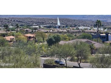 Scenic community view featuring lush landscaping and a water fountain, with a mountain backdrop at 13227 N Mimosa Dr # 107, Fountain Hills, AZ 85268