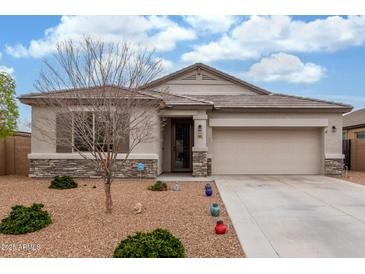 Charming single-story home with a stone accent, desert landscaping, and a two-car garage at 13603 W Remuda Dr, Peoria, AZ 85383