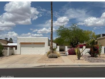 Charming single-story home with desert landscaping, a two-car garage, and beautiful desert landscaping at 1510 E Wescott Dr, Phoenix, AZ 85024