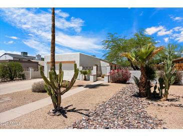 Charming single-story home featuring desert landscaping and white exterior paint at 1510 E Wescott Dr, Phoenix, AZ 85024