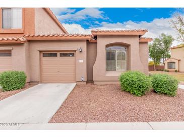 Charming single-story home with a well-maintained front yard and attached one car garage at 2600 E Springfield Pl # 10, Chandler, AZ 85286