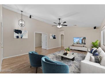 An interior picture of a living room showing modern decor, tile floors, and a ceiling fan at 33290 N Roadrunner Ln, San Tan Valley, AZ 85144