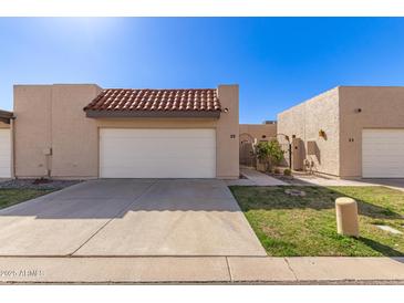Charming single-story home featuring a one-car garage and gated entrance at 3345 E University Dr # 29, Mesa, AZ 85213