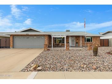 Charming single-story brick home featuring a well-maintained front yard with decorative rock and a two-car garage at 4432 E Carmel Ave, Mesa, AZ 85206