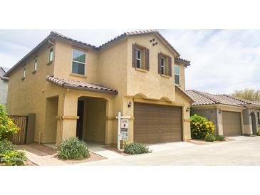 Charming two-story home with a tile roof, two-car garage and covered entry way at 6853 E Posada Cir, Mesa, AZ 85212