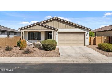 Charming single-story home with a well-maintained front yard and two-car garage at 730 W Wind Cave Dr, San Tan Valley, AZ 85140