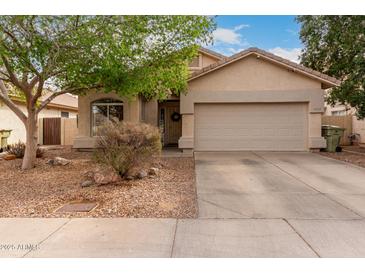 Charming single-story home with a two-car garage and low maintenance front yard at 8325 N 61St Ln, Glendale, AZ 85302
