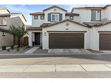 Inviting two-story home featuring a two-car garage and manicured front yard landscaping at 1255 N Arizona Ave # 1043, Chandler, AZ 85225