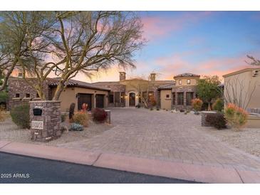 Stunning desert home featuring a brick driveway, lush landscaping, and a private two-car garage at 15956 E Tombstone Trl, Fountain Hills, AZ 85268
