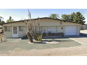 Charming single-story home with desert landscaping and attached one car garage at 1630 S Sossaman Rd, Mesa, AZ 85209