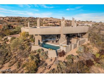 Stunning aerial view of a modern home with a pool nestled in a desert landscape at 41823 N 111Th Pl, Scottsdale, AZ 85262