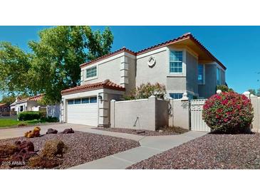 Charming two-story home with a two-car garage and well-manicured front yard at 6720 W Mcrae Way, Glendale, AZ 85308