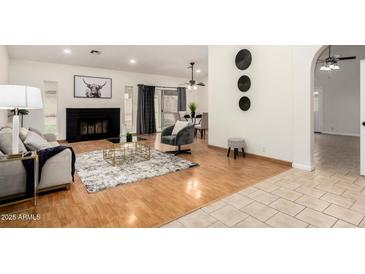 Spacious living room with fireplace, hardwood floors, and neutral tones creating a comfortable atmosphere at 7120 W Columbine Dr, Peoria, AZ 85381