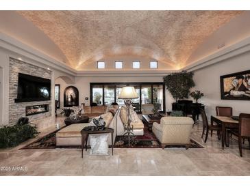 Elegant living room featuring a unique brick ceiling, fireplace, and ample seating at 8406 E Calle Buena Vis, Scottsdale, AZ 85255