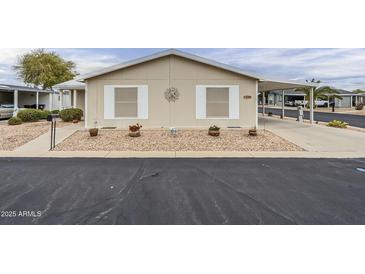 Cozy single-story home with desert landscaping, charming details, and covered parking space at 890 E Tee St, San Tan Valley, AZ 85140