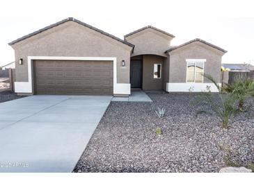 Charming single-story home with desert landscaping and a two-car garage at 10005 W Mission Dr, Arizona City, AZ 85123