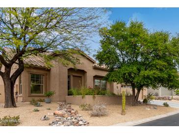 Inviting front yard with desert landscaping and charming facade, creating a warm welcome at 10796 E Betony Dr, Scottsdale, AZ 85255