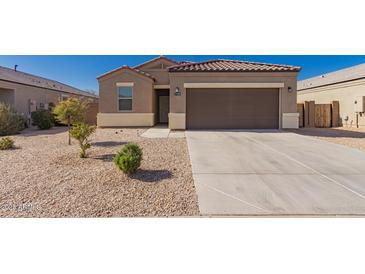 Charming single-story home with a well-maintained yard and two-car garage, perfect for comfortable living at 1178 E Tyler Ln, Casa Grande, AZ 85122