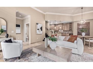 Bright and airy living room connecting to the kitchen and featuring neutral tones at 12625 N Saguaro Blvd # 203, Fountain Hills, AZ 85268