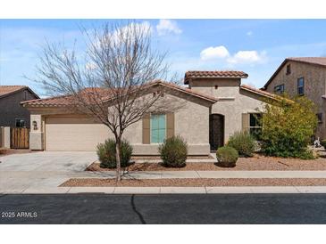 Charming single-story home showcasing desert landscaping, a two-car garage, and a red tile roof at 19372 E Timberline Rd, Queen Creek, AZ 85142