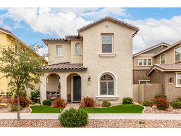 Charming two-story home with a well-manicured front yard, covered porch and desert landscaping at 2571 S Melvin St, Gilbert, AZ 85295