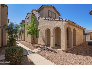 Charming two-story home featuring an arched entryway and low-maintenance desert landscaping at 5472 W Fulton St, Phoenix, AZ 85043
