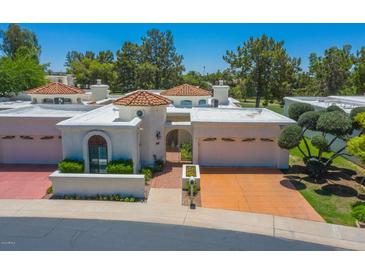 Inviting front exterior featuring a private entry and two-car garage, showcasing a charming desert home at 5801 N 25Th Pl, Phoenix, AZ 85016