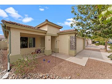 Charming single-story home featuring a well-maintained front yard and a two car garage at 10817 W Wilshire Dr, Avondale, AZ 85392