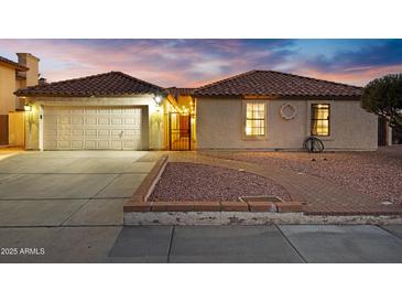 Charming single-story home featuring a tile roof, stucco exterior, and well-maintained landscaping at 5431 W Cochise Dr, Glendale, AZ 85302